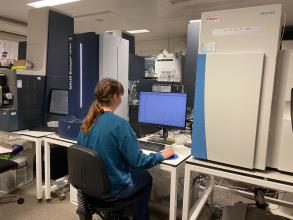 A research assistant using a MALDI Biotyper Sirius instrument